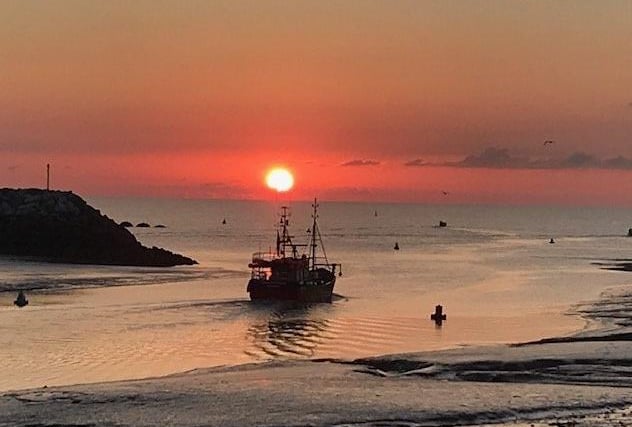Fishing boat setting out at dawn from Sovereign Harbour, taken by Helen Putman with an iPhone7. SUS-200909-100800001