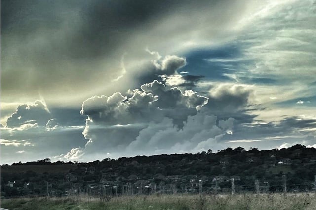 Fantastic cloud formations over Friston and East Dean, captured with an 11 Pro Max by Melanie Wells. "The sky  resembled the angry spewing of a volcano, beautifully backlit by the sun and with a fluffy cloud in the foreground looking completely out of place!  All the signs were there for a storm but all that materialised was one flash of lightning," she said. SUS-200909-101055001