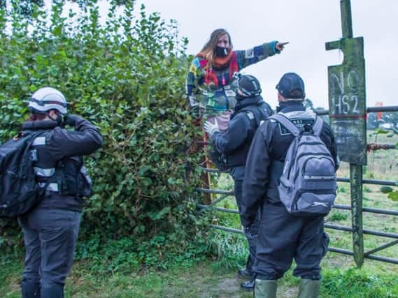 Protester remonstrates with police and HS2 staff trying to clear the site