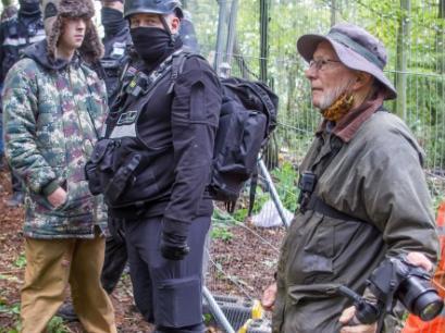 An elderly protester stands firm at the Jones Hill Wood camp