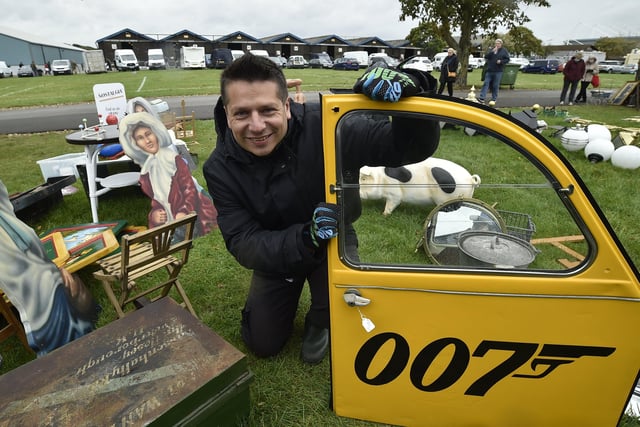 Antiques Fair at the Arena East of England showground. Peterborough dealer Flav Cipriano with a 2CV door EMN-200210-181539009