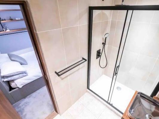 This luxury apartment also has a stunning fitted modern bathroom with a walk-in shower.