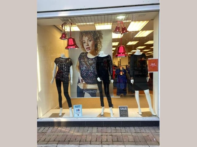 Roman Originals added red Christmas bells to the window display