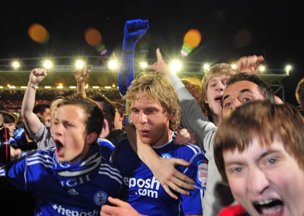 Posh striker Craig Mackail-Smith and fans celebrate the famous 2011 League One play-off semi-final victory over MK Dons.