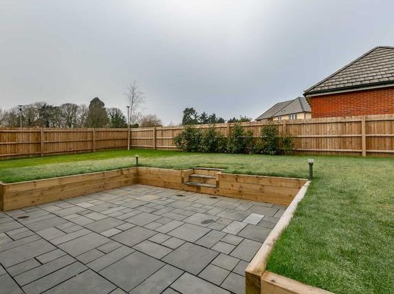 The garden contains patio and a large lawn raised by timber sleepers which is enclosed by timber fence panels