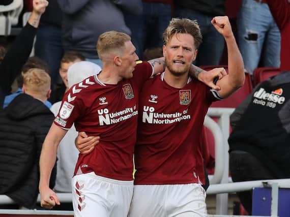Fraser Horsfall and Mitch Pinnock are all smiles after Cobblers double their lead. Pictures: Pete Norton.