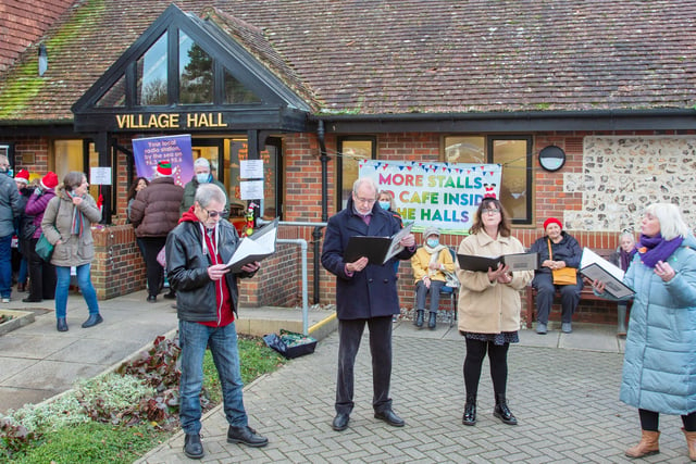 East Dean held its Christmas fair on Saturday December 18 at the village hall. As well as the traditional stalls, the event featured carol singing. Herald reader Barry Davis took this photograph of the carol singers outside the village hall, with a Canon EOS 5d camera. SUS-211220-113404001