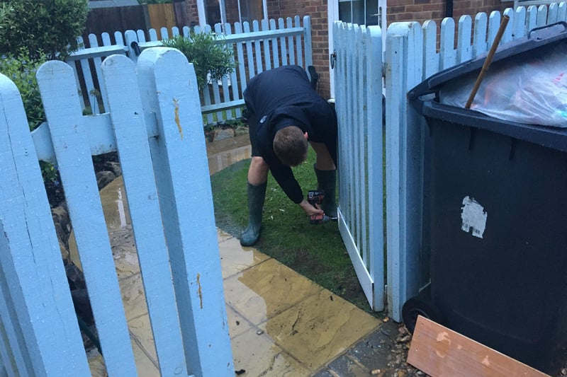A Freeks Lane resident nails some protection to a fence.