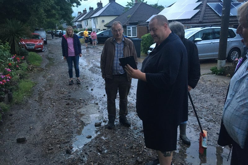 Councillor Simon Hicks (Leylands) watches Eddie Holland's video of the flooding.