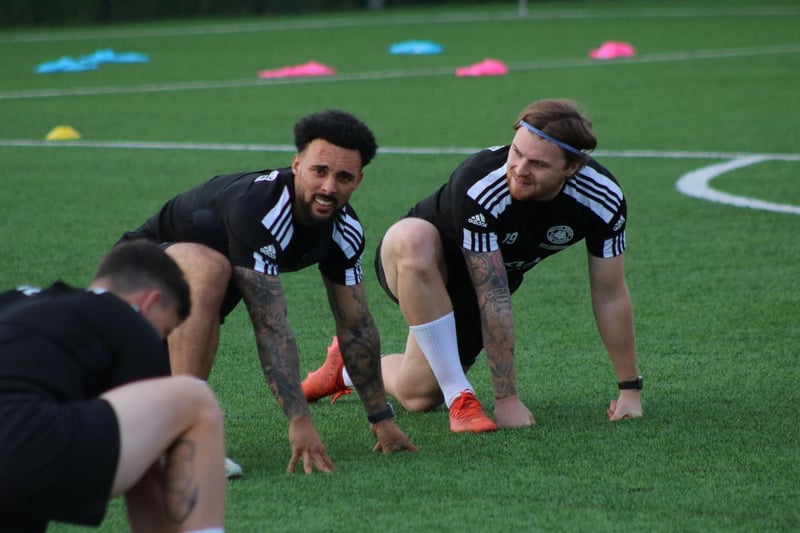 Club captain Jay Rollins and new signing Jordan Preston do some stretches. Photo: Oliver Atkin