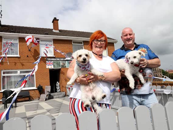 Kim and Neil Millar with their dogs as they watch the parade. (Photo: Pacemaker Press)
