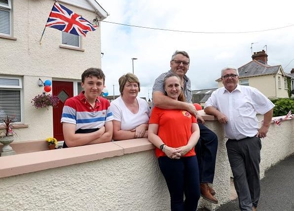 Pictured: Gerry and Linda Johnson celebrate alongside their neighbours Alan, Paula and Raymond, in their garden. (Photo: Pacemaker Press)