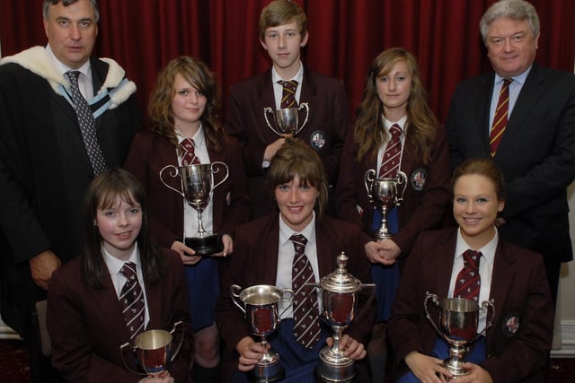 Mr. Jack Magill, right, Headmaster, and Mr. William Lynn, Senior Teacher, pictured with Year 11, 12 and 13 special prizewinners, from left, seated Leona Reid, The Joy Coskery Cup for Spanish, Amy Chambers, The Curzon Mowbray Cup for Spoken French, The A D McClay Cup for History, The Joanne Mathers Prize for Geography, The McIlroy Prize for Arts Subjects and The Dunluce Prize for Science Subjects, and Laura Carroll, The A D McClay Cup for Business Studies; standing, Joanne Campbell, The Leslie McLaughlin Cup for Additional Maths, Mark Watson, The NW Telegraph Cup for Mathematics, and Heather Manning, The Roulston Cup for Academic Excellence in Year 12, at the annual prize distribution held by Foyle College in The Guildhall. LS37-110KM10