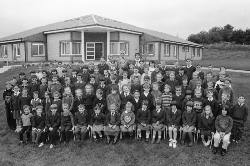 Pupils and staff of St. Patrick’s National School, Drumfries, pictured outside their new school building.