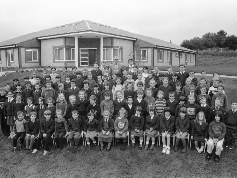 Pupils and staff of St. Patrick’s National School, Drumfries, pictured outside their new school building.