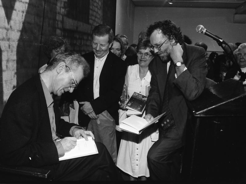 Members of the public wait anxiously to have their copies of ‘Reading in the Dark’ signed by the author Seamus Deane.