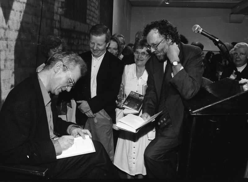 Members of the public wait anxiously to have their copies of ‘Reading in the Dark’ signed by the author Seamus Deane.