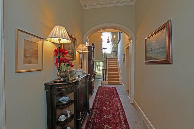 A fine stone columned and portico over the front door opens into a "generous", stone flagged hallway to original Georgian arch, staircase to the first floor and under-stair storage, rear door to the garden.