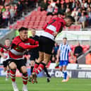 Doncaster's Luke Molyneux heads home the first goal.