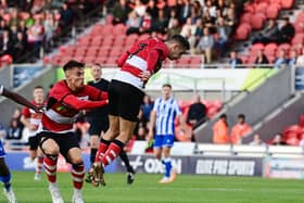 Doncaster's Luke Molyneux heads home the first goal.