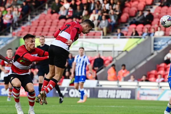 Doncaster's Luke Molyneux heads home the first goal.