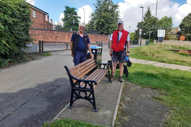 Alastair Lang and Jon Lyall are both volunteers for Friends of Town Fields next to a bench reinstalled by Doncaster Council.