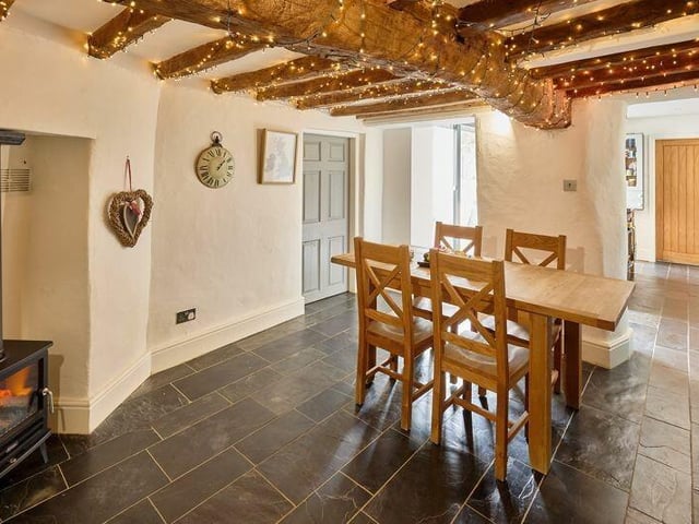 The oak-beamed dining area, with warming multi-fuel burner.