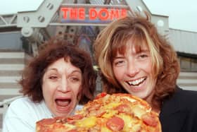 Staff at the the area's two sports Domes - The Doncaster Dome, and Barnsley's Metrodome - delivered a pizza to each other to raise money for Children in Need in 1998. Our picture shows Dome duty manager Shelley Armitgae (right) and the Metrodome's admin/finance officer tucking into one of the pizzas.