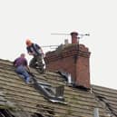 Workmen removed roof slates as the demolition of empty house in Edlington got underway in 2001