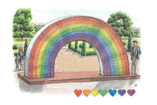 The monument is currently a sky blue arch. Once completed, it will resemble a rainbow