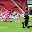 Doncaster's players take the knee before the opening home game of the season against Sutton United.