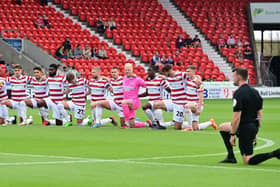 Doncaster's players take the knee before the opening home game of the season against Sutton United.