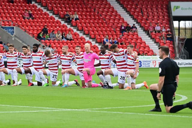 Doncaster's players take the knee before the opening home game of the season against Sutton United.