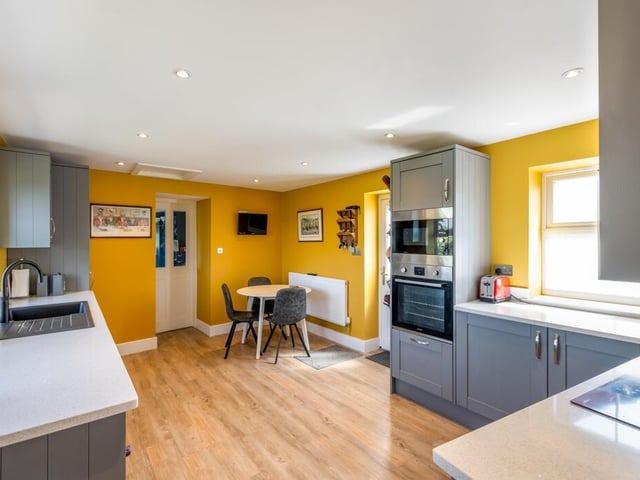 The bright and modern breakfast kitchen in the annexe fitted units and integrated appliances.
