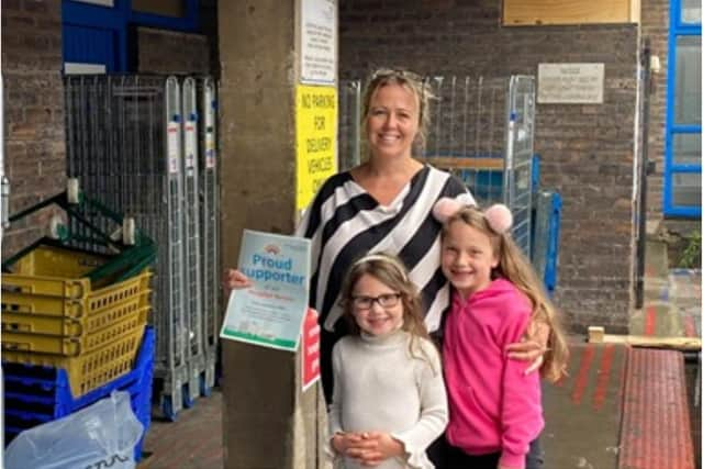 Sam Foster with her daughters at the hospital after her PPE donation.