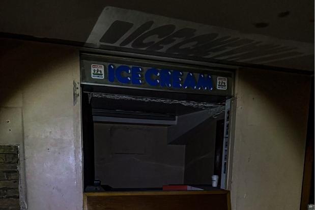 The signs for an ice cream kiosk are still in place.