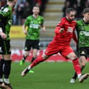 Harrison Biggins wins a challenge in midfield against Leyton Orient.