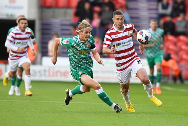 Tommy Rowe chases the ball against Swindon Town.