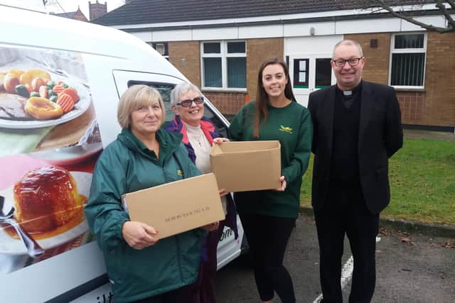  Father Darren Reid and Marilyn Connell (second left) from Churches Together receiving boxes from Wiltshire Farm Foods
