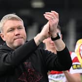 Rovers' manager Grant McCann salutes the away end.