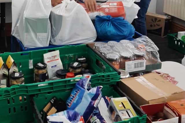 Ros helping to pack a food parcel.