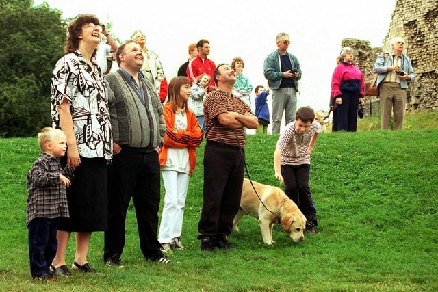 Early risers keep their eyes peeled skywards as the last of the hot air balloons rises above Conisbrough Castle in August 1998