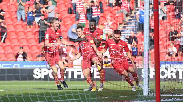 Rovers celebrate Tommy Rowe's winner against Morecambe. Photo: Howard Roe/AHPIX LTD