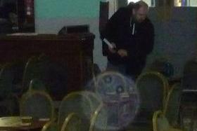 Paranormal investigator Dean Buckley picking equipment up of the table. Photo taken by his nephew Jack Buckley in the afternoon at the club.