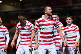 Doncaster's Tom Anderson celebrates his goal against Rochdale.
