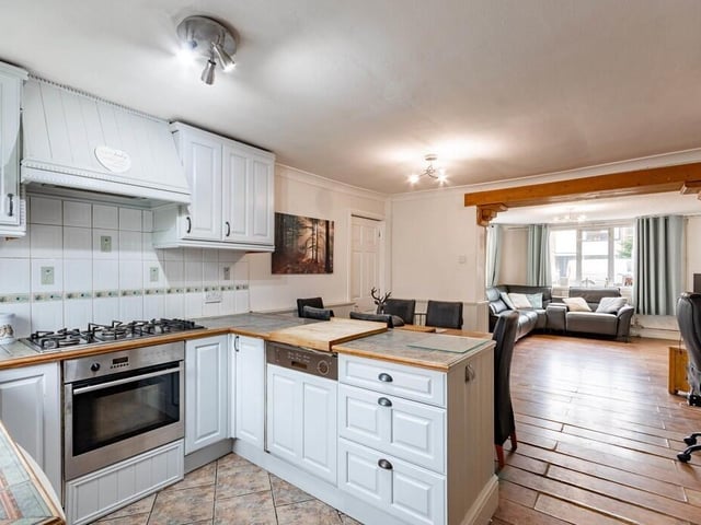 The attractive open plan and 'zoned' interior, with fitted kitchen in the foreground.