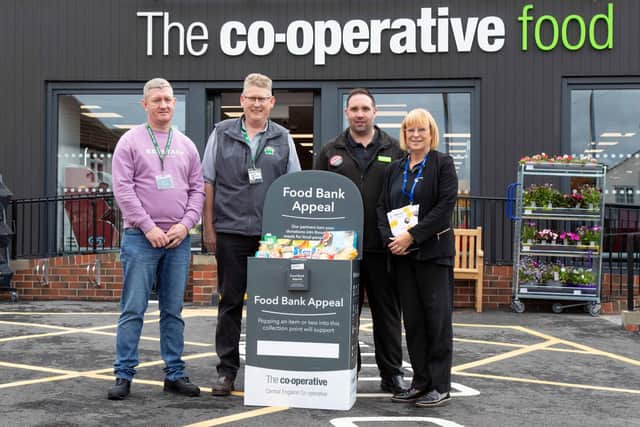 Central England Co-op Store Manager Liam Turner presents a donation of vital food and essentials to Bassetlaw Foodbank