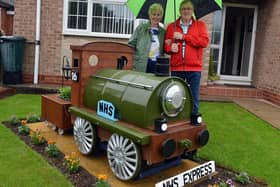 Michael Julian made a train in his front garden during lockdown. Michael and wife Ann Julian with the train.