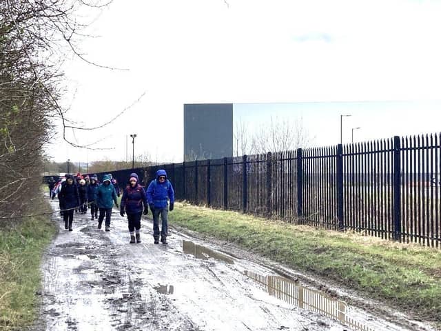 Along side the iPort fence