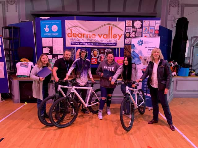 Cathy Kemp,  Practice Manager of Coriel Orthopaedic pictured with young people  Dearne Valley Personal Development Centre(DVPDC) and the bikes donated by Coriel Orthopedic.
